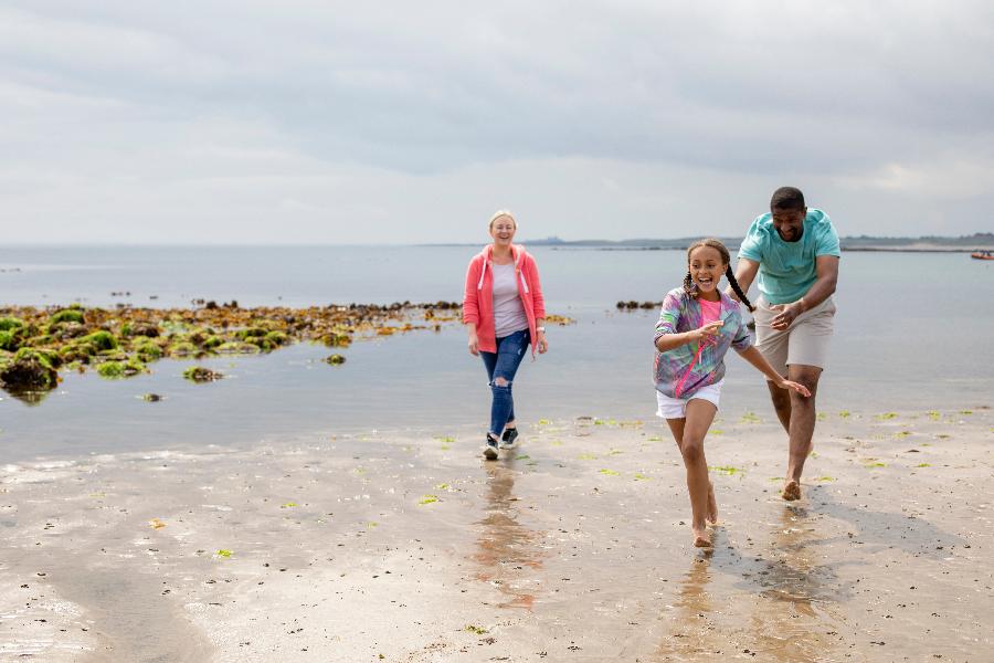 Family walking on a beach