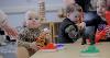Babies playing at a table 