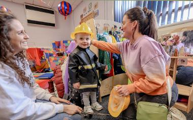 Dressing up area with parents and kid